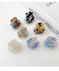Close-up of seven mini acetate hair claws with marble and tortoiseshell patterns