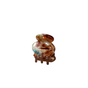 Small tortoiseshell acetate hair claw clip with amber texture for women's hair styling