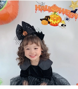 Detail of girls Halloween bow headband with sequin pumpkin and spider on mesh skirt