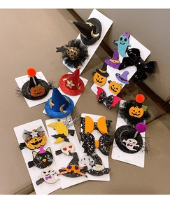 Detail of Halloween hair clips featuring glitter pumpkins, ghosts, and bats on cards