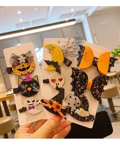 Set of Halloween hair clips featuring glitter pumpkins, ghosts, and bat wing bow accents