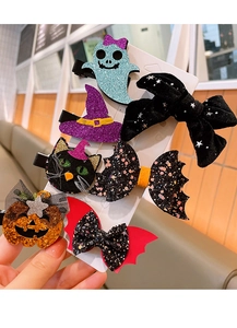 Detail shot of Halloween hair clips featuring ghost, bat, and pumpkin designs with glitter