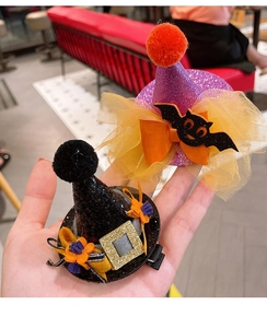 Detailed view of Halloween witch hat hair clips with glitter, mesh bows and bat patterns