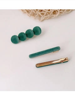 Detailoverzicht van donkergroene flock haarclips met gouden metalen clips aan achterkant