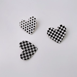 Three-piece heart hair clip set with checkered, polka dot, and houndstooth patterns