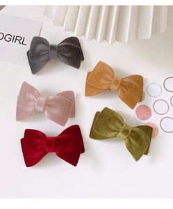 Detailed flat lay of high-quality velvet bow hair clips in five elegant autumn colors