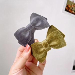 Elegant velvet bow hair clips in grey and olive green for a minimalist feminine hairstyle