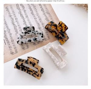 Detailed set of four hollow rectangular acetate hair claws in chic leopard and marble patterns