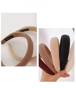 Detail shot of padded fabric headband showing handmade label and premium texture