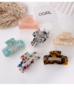 Detail view of six large acetate rectangular hair claws with various patterns and patterns