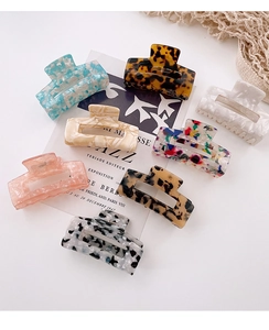 Collection of eight rectangular acetate hair claws in various floral and marble patterns