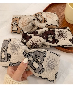 Detailed close-up of knitted bear hairbands in khaki, dark coffee, and light gray colors