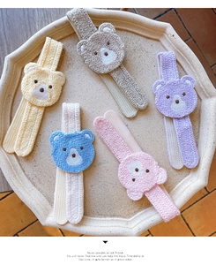 Detailed view of plush bear hair accessories in five soft pastel macaron colors