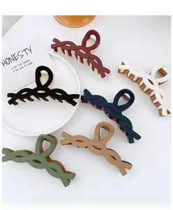 Detailed view of large matte twist hair claws in six colors like black and wine red
