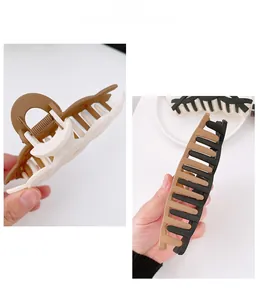 Detail of matte plastic hair claw clip with strong metal spring and two-tone color design
