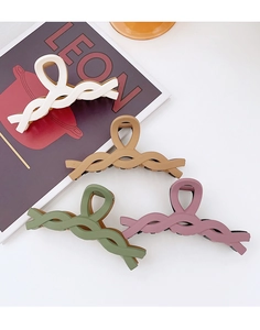 Detail view of 4 large matte hair claws in braided spiral design for thick hair