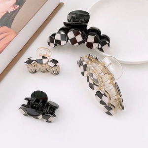 Modern checkered pattern hair claw clips set in black and white for stylish hair styling
