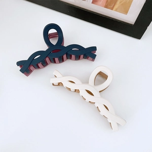 Matte twisted plastic hair claw clips in navy blue and cream white color variants