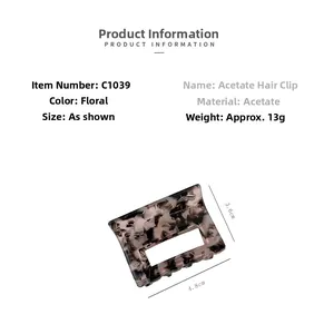 Detail view of a 4.8cm square acetate hair claw clip with vintage floral pattern texture