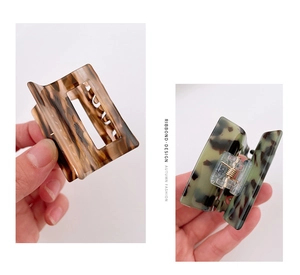 Macro detail of tortoiseshell acetate claw clips featuring a hollow square design