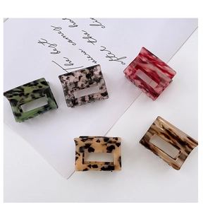 Assorted acetate square hair claws in leopard and marble patterns on white background
