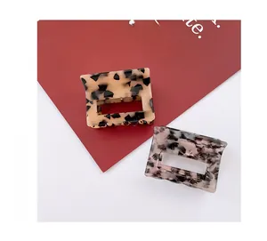 Detail of square acetate hair claws featuring tortoiseshell and marble texture patterns