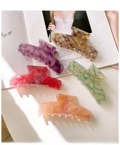 Detailed view of five marble texture hair claws in various elegant acetate colors