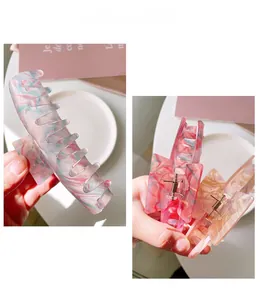 Detailed view of large acetate claw clip with colorful marble pattern and metal spring
