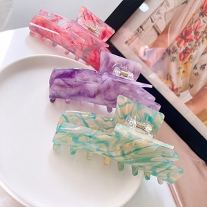 Chic French acetate hair claw clips in marble pink and purple for elegant hairstyling