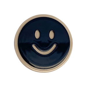 Fermaglio per capelli rotondo in smalto nero con faccina sorridente dorata su bianco