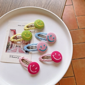 Set of 6 colorful fabric smiley face hair clips for girls in a decorative tray