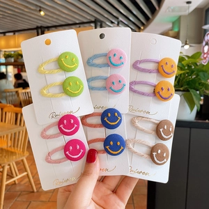 Colorful embroidered smiley face hair clip set for kids with woven fabric edges