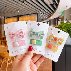 Cute floral polka dot bow hair clips for girls set on display cards in three soft colors