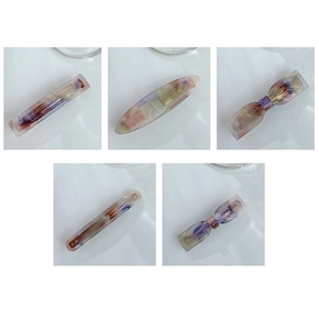 Detailed macro view of acetate hair clips featuring premium purple marble textures