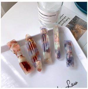 Detail of 5-piece acetate hair clip set with marble texture in soft pearlescent tones