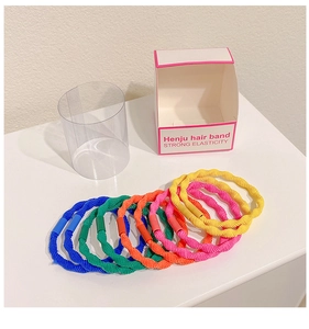Macro shot of colorful high elasticity spiral hair bands with braided texture and clasps