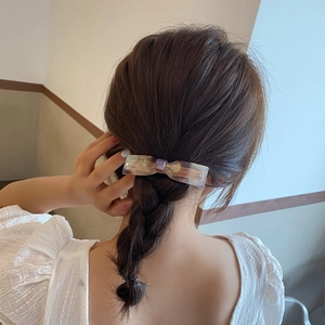 Elegant mermaid scale bow hair clip in purple and cream acetate for back styling