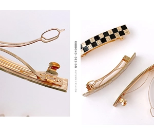 Detail view showing metal spring clips with checkered patterns and gold finish