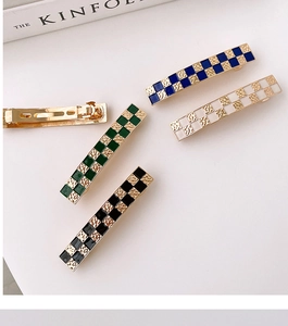 Detailed view of checkerboard hair clips with alloy spring mechanism and colorful patterns