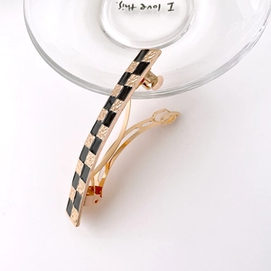 Checkerboard pattern spring hair clip with elegant black and gold textured square design