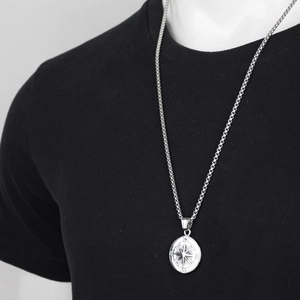 Hip hop compass pendant necklace in silver stainless steel on a black t-shirt