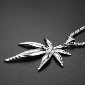Macro shot of polished silver maple leaf pendant on a durable stainless steel box chain