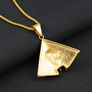 Macro detail of golden pharaoh pendant back with brushed finish and venetian chain