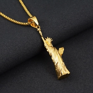 Détail macro du pendentif Statue de la Liberté doré avec sculptures de couronne et de robe