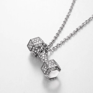 Close-up of silver-tone dumbbell pendant with micro-pave crystals on an O-chain