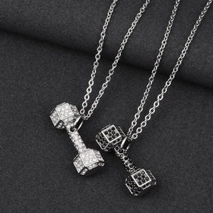 Close-up of hip hop dumbbell pendant necklaces in silver and gun black with micro-pave stones