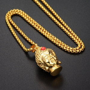 Detailed golden Buddha head pendant necklace with red gemstone and round box chain