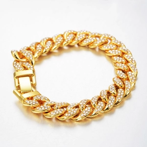 Close-up of golden Cuban link bracelet with pavé-set rhinestones and a secure plug-in clasp