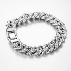 Macro detail of silver-tone iced out Cuban link chain with sparkling pavé crystals