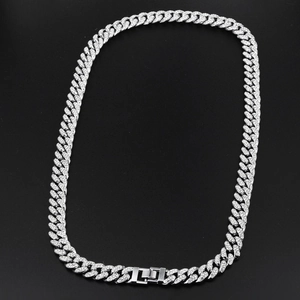 Detail view of hip-hop flat link chain necklace with sparkling rhinestones on black background